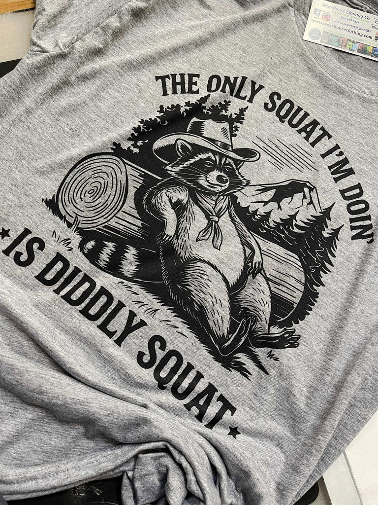 The Only Squat I’m Doin’ Is Diddly Squat Tee 🦝🌲